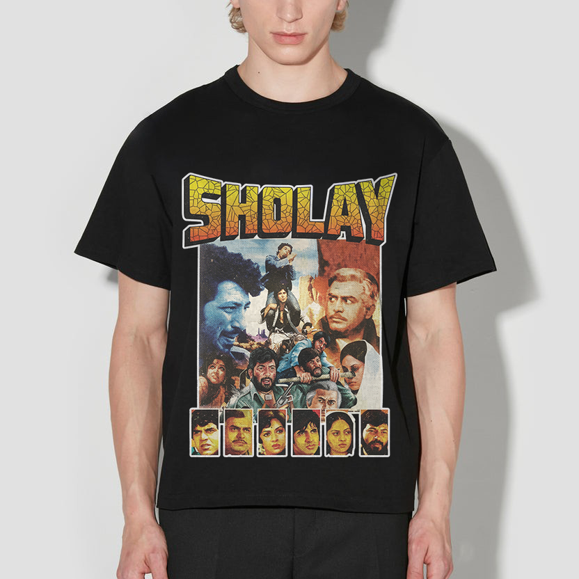 Person wearing a black t-shirt with 'Sholay' graphic design on a white background